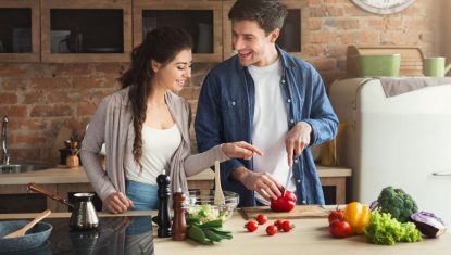 Happy couple cooking dinner together