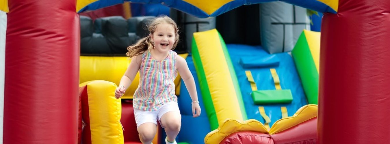 Child jumping on playground trampoline. Kids jump.