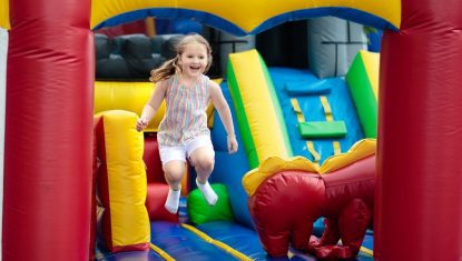 Child jumping on playground trampoline. Kids jump.