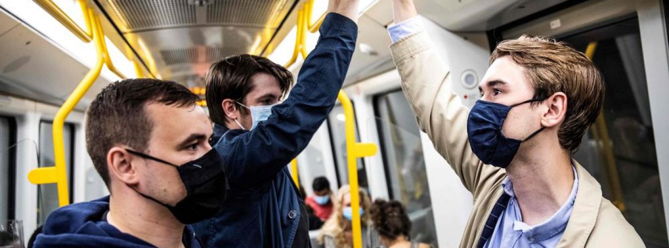 People wear mask on a metro train in Copenhagen shortly after midnigh