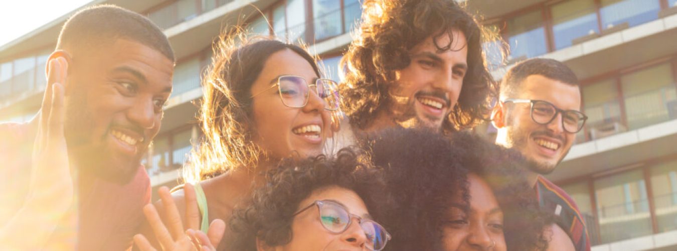 Joyful multiethnic friends taking funny group selfie