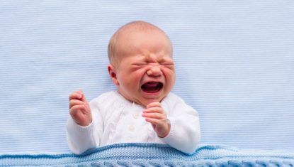 Newborn baby boy on a blue blanket