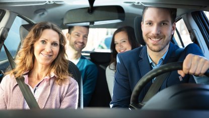 Smiling People Sitting In Car