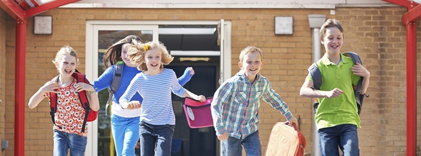 Schoolchildren Running Into Playground At End Of Class