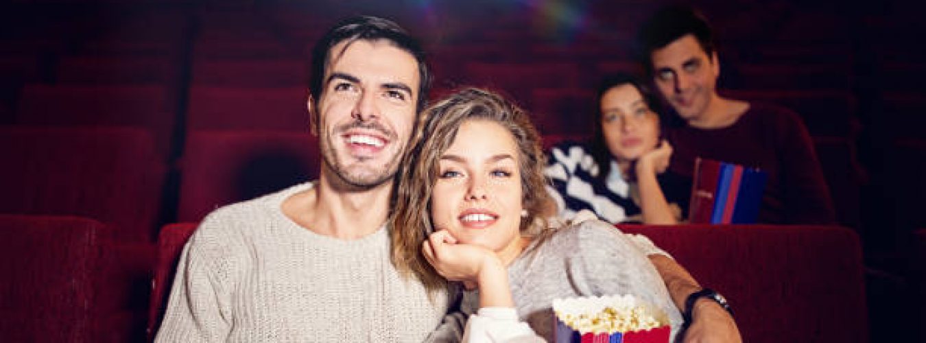 Couple is watching movie in the cinema theater