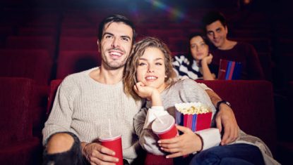 Couple is watching movie in the cinema theater
