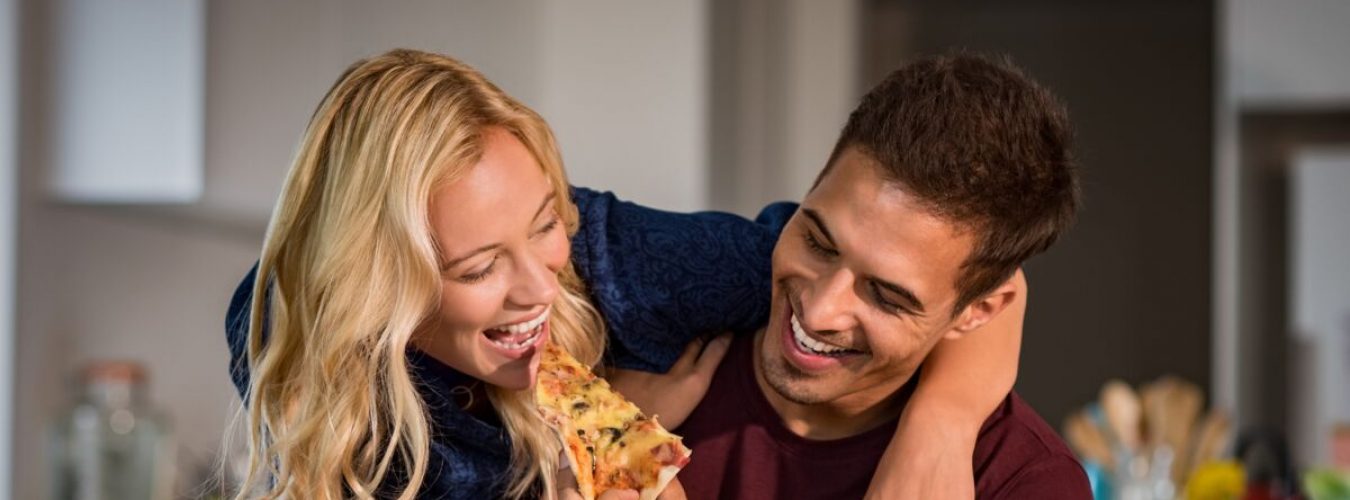 Couple enjoying eating pizza
