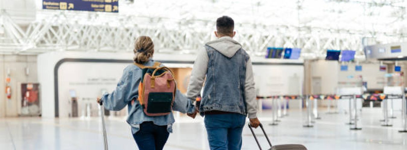 Couple at the airport walking to board