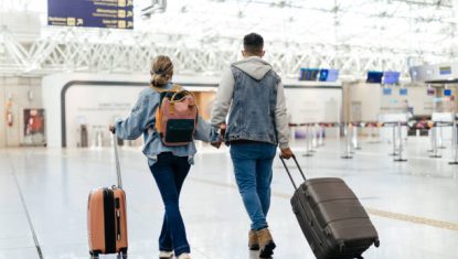 Couple at the airport walking to board