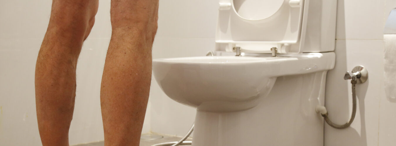 Man stood over toilet