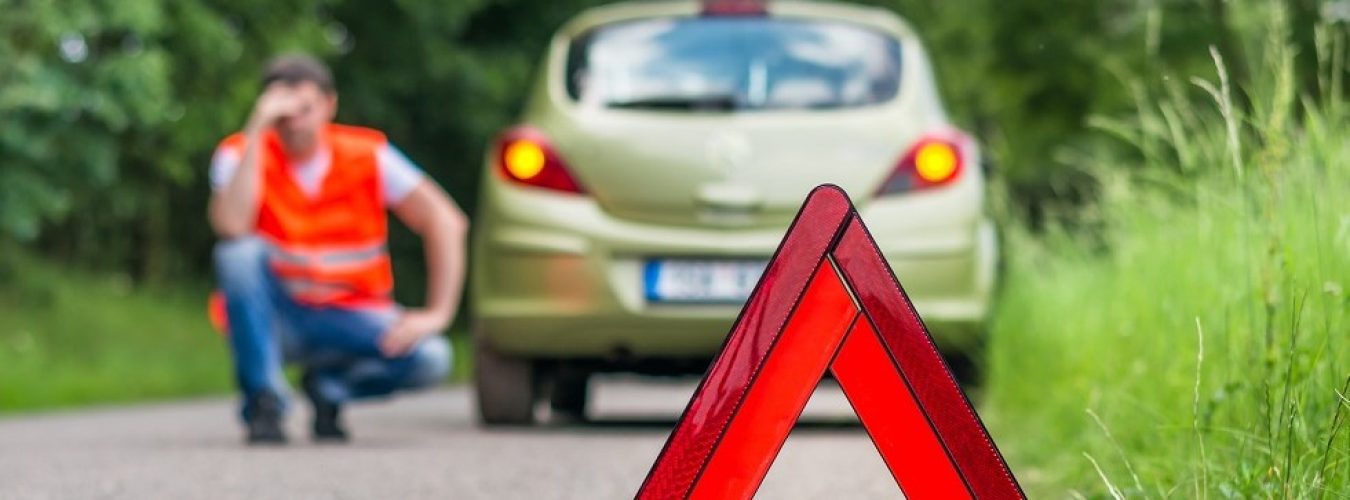 Broken car on the road and unhappy driver