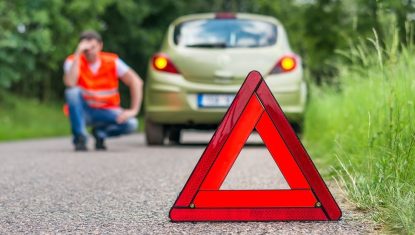 Broken car on the road and unhappy driver